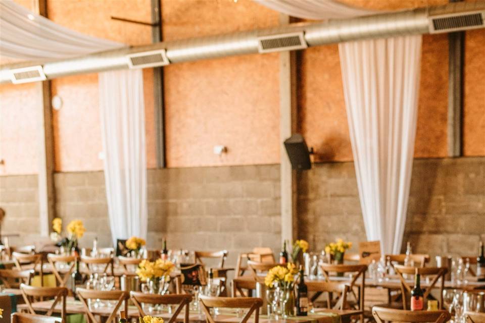 Boulton & Paul Bar event space with pipe-and-drape decor for rustic industrial wedding venues.