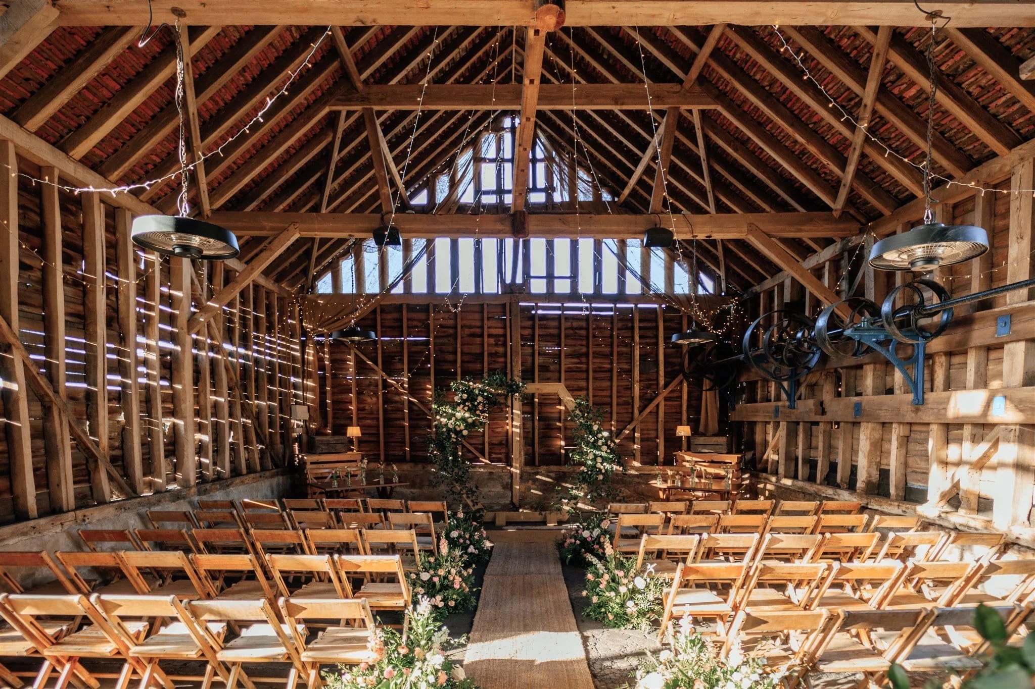 Rustic wedding ceremony venue at The Old Workshop, Lodge Farm with exposed timber framing.