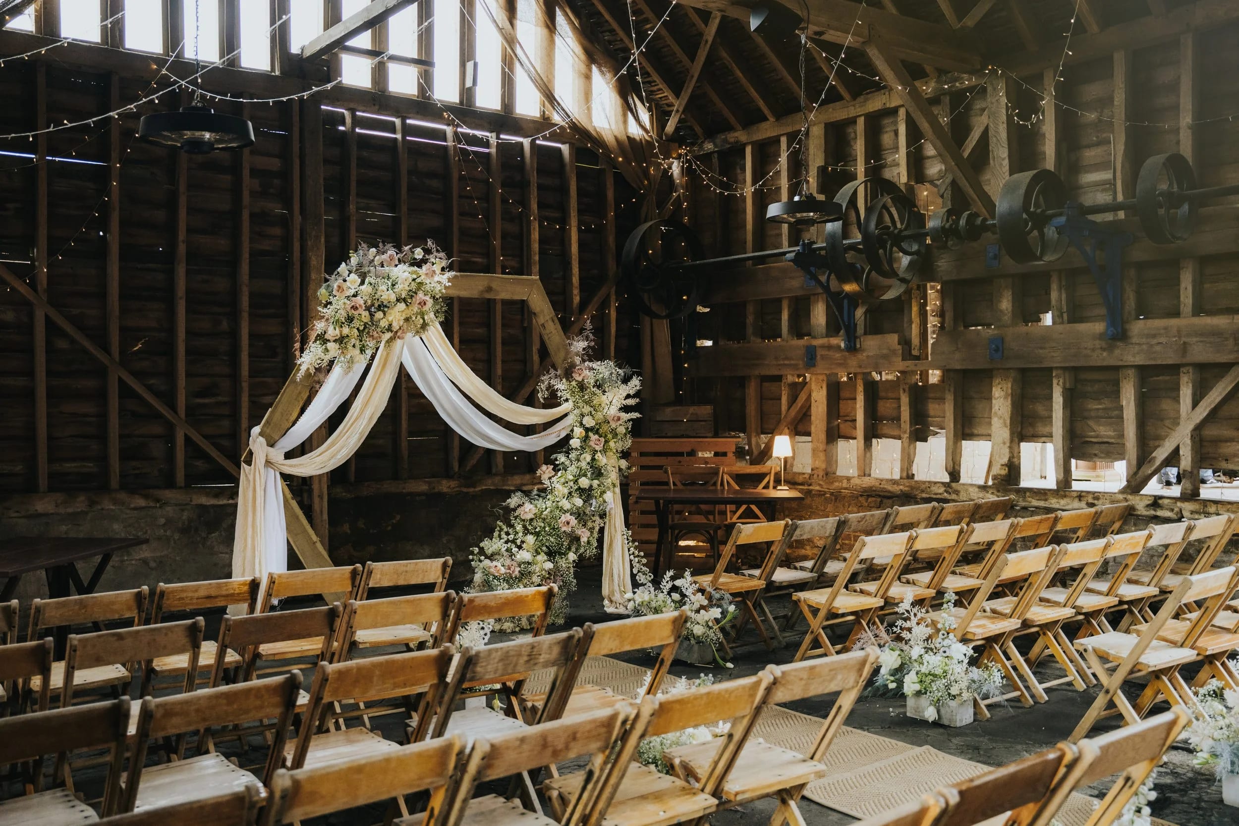 Rustic barn wedding ceremony setup with hexagonal altar at The Lodge Farm for event venue hire.