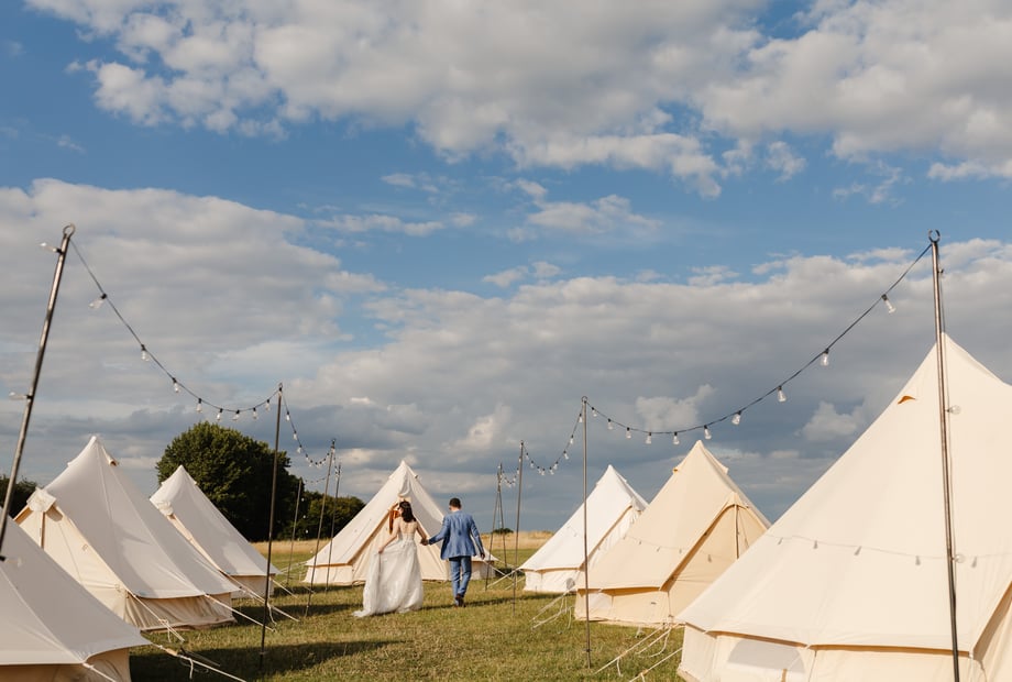 Glamping event setup at The Barns at Lodge Farm with aesthetic festoon lighting.