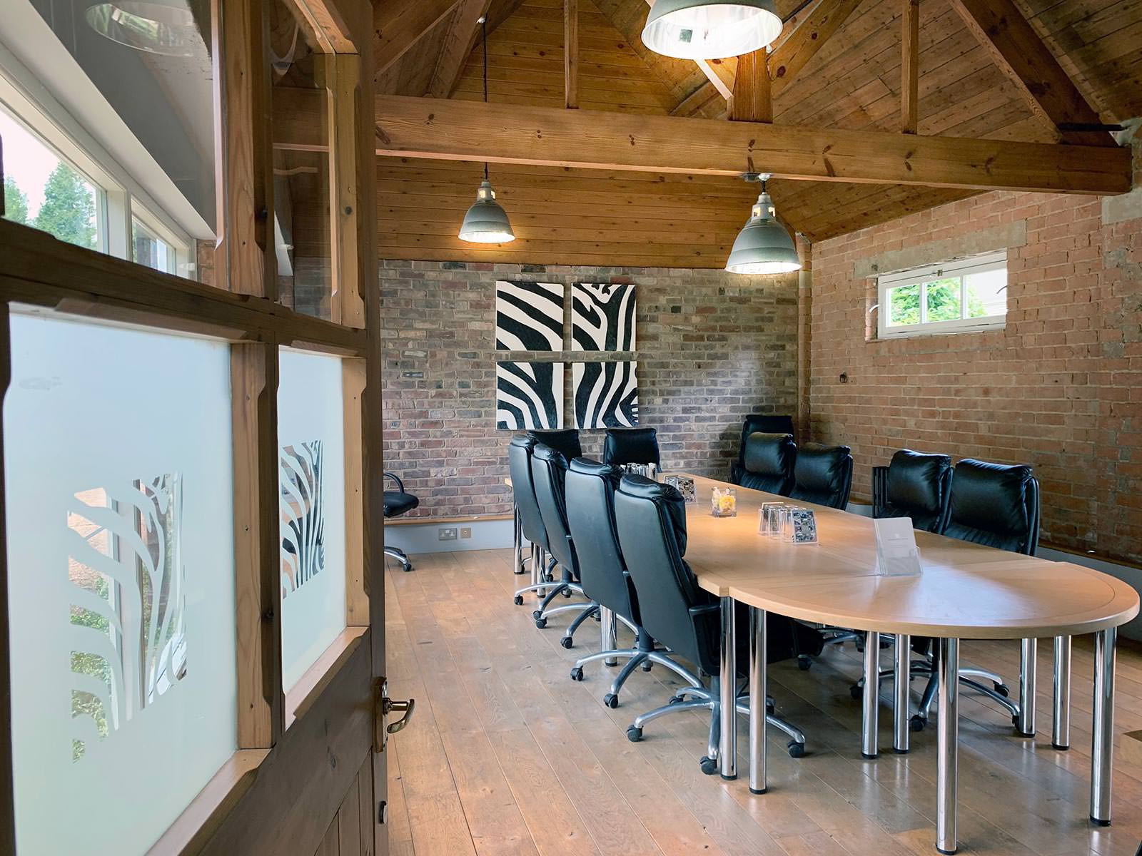 Rustic-chic boardroom with exposed brick for exclusive executive meetings and brainstorming.