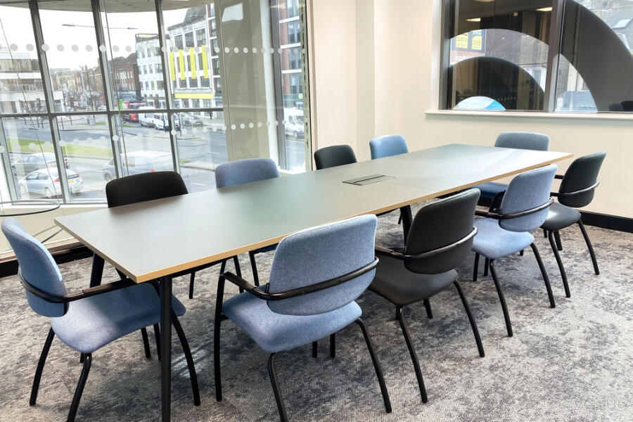 Boardroom-style breakout area with natural light for corporate meetings and team collaboration.