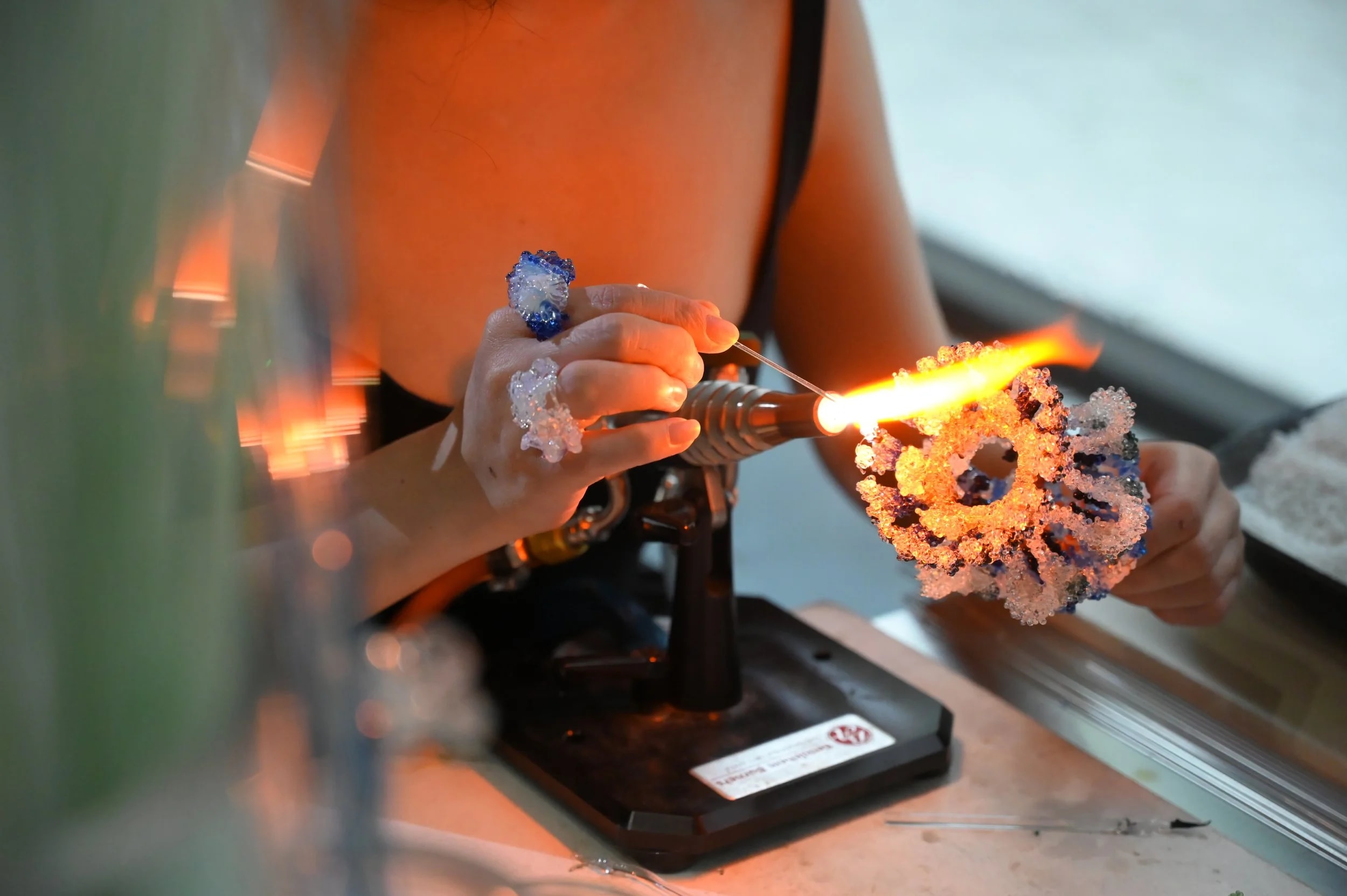 Lampworking studio artisan demonstration for interactive experiential event activation.