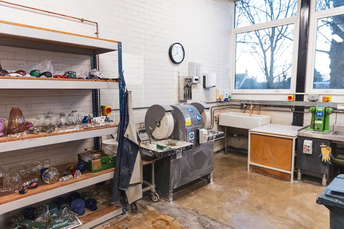 Lampworking studio production space for creative workshops and industrial craft events.