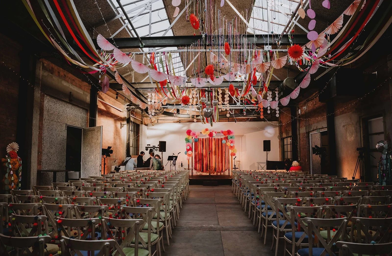 St Stephen’s Hall industrial venue with theater seating and whimsical ribbon decor for events.
