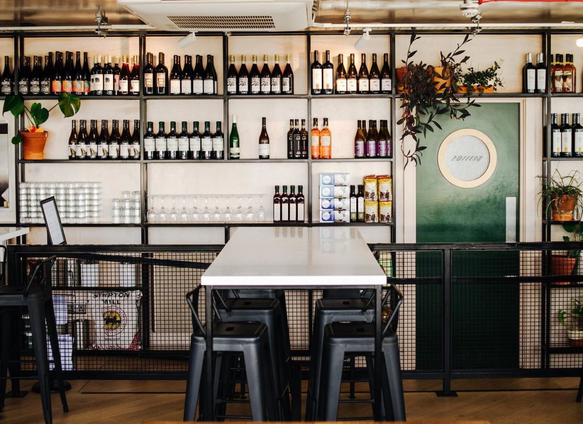 Industrial wine bar with communal table for networking events and cocktail receptions.