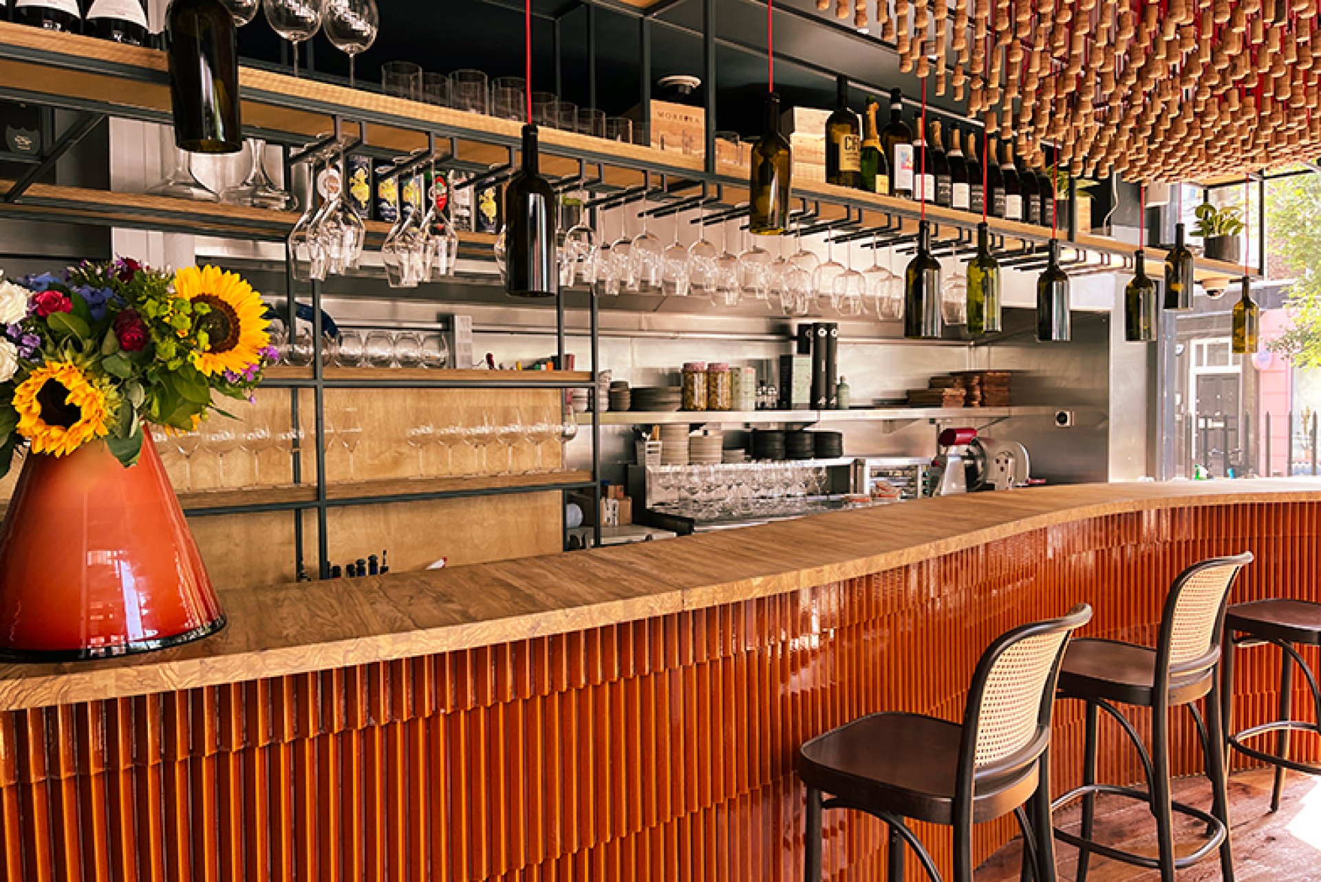 Modern wine bar venue for networking events featuring branded decor for corporate receptions.
