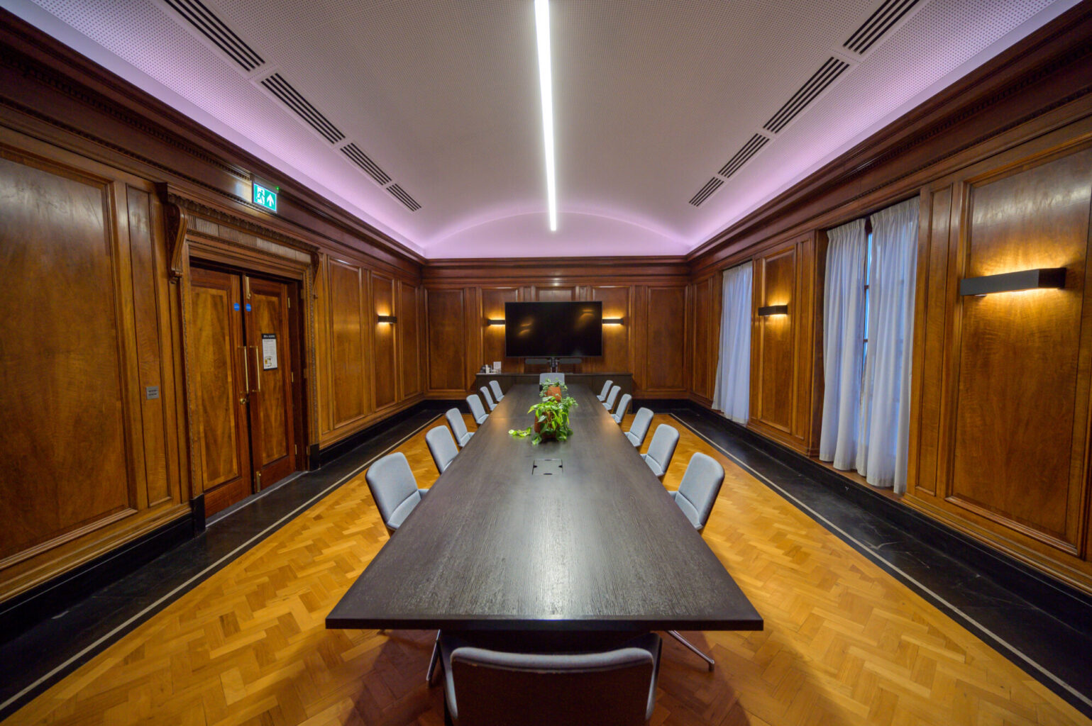 Executive boardroom with wood paneling for professional meetings and corporate events.