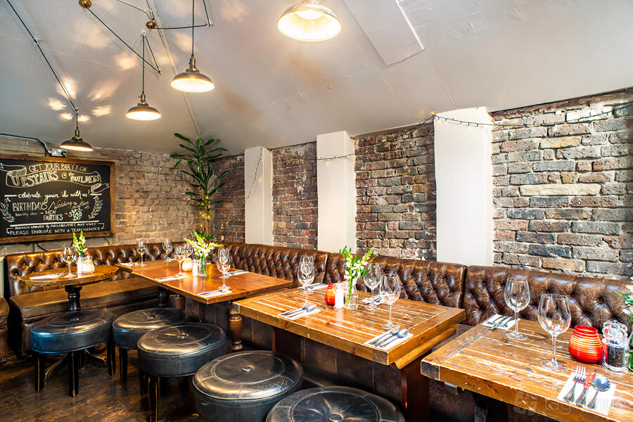 Brunel Bar rustic semi-private dining space with tufted banquettes for events and parties.