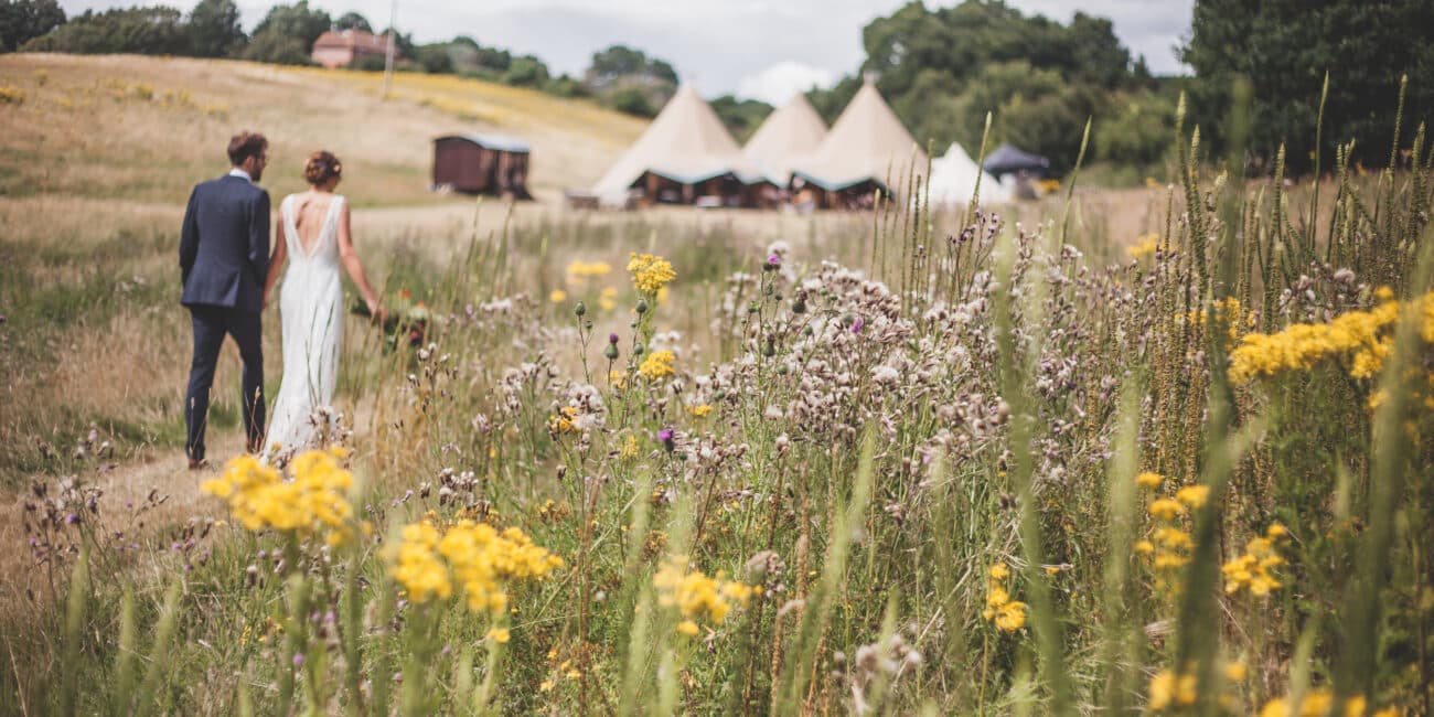 Rustic tipi outdoor wedding venue in Sussex wildflower meadow and woods.