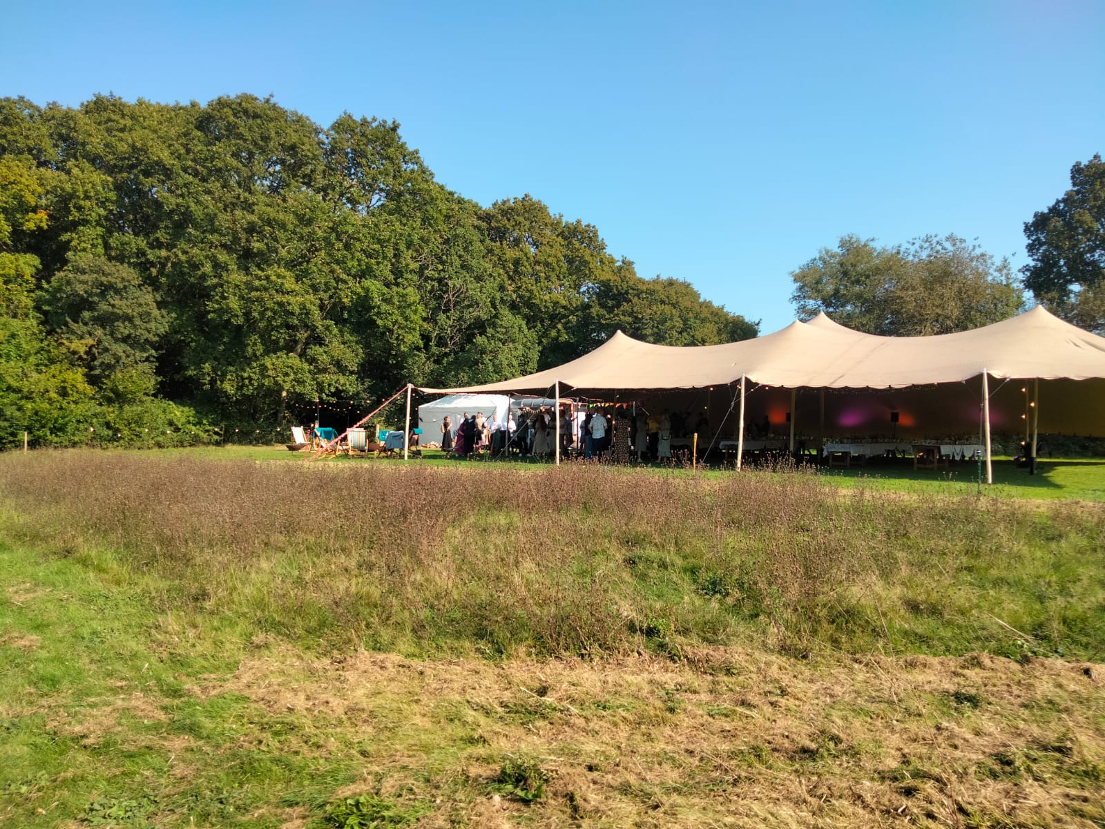 Stretch tent in Sussex meadow for outdoor weddings and corporate events.