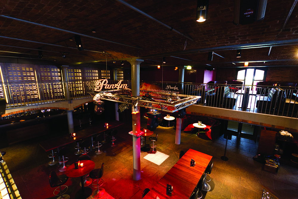 Industrial-chic private function venue with mezzanine for corporate events and evening receptions.