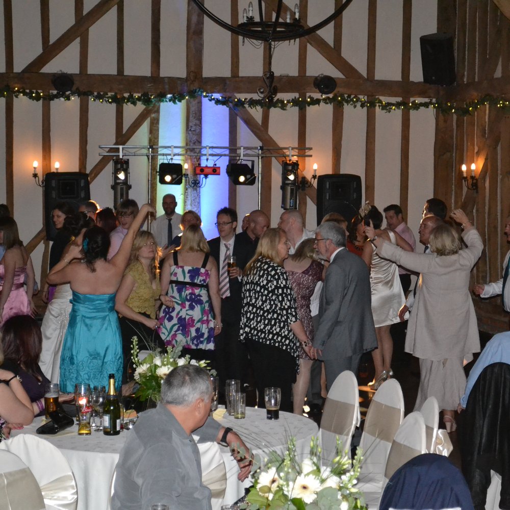 Rustic barn wedding reception venue with professional lighting and AV at The New Chichester Hotel.