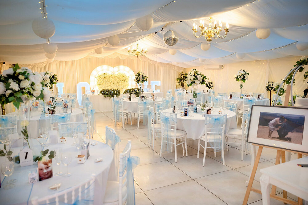 Luxury marquee wedding reception at The New Chichester Hotel with elegant floral decor.