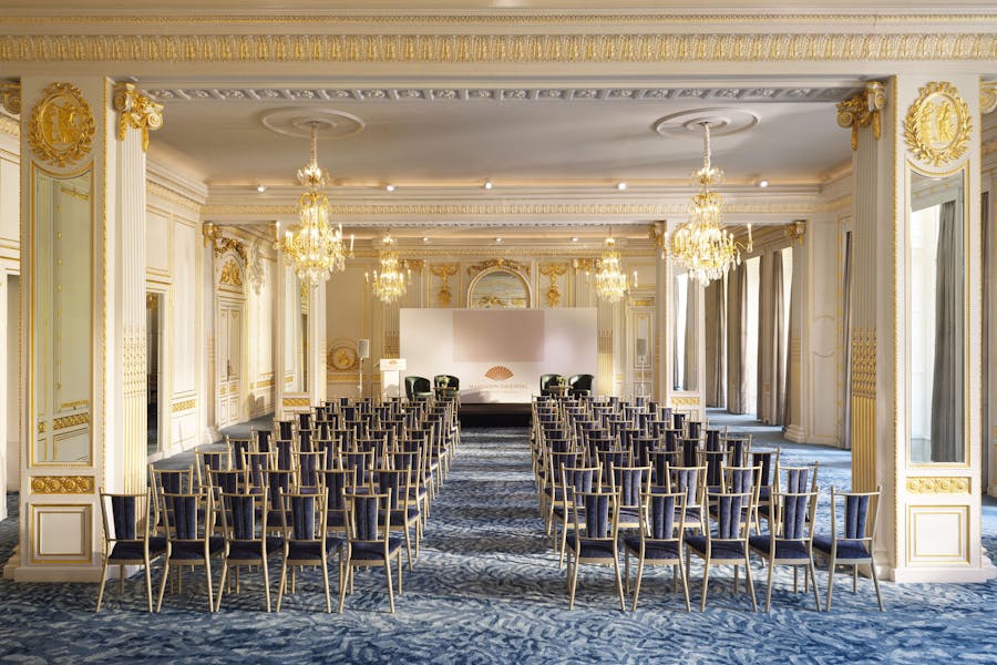 Luxury Palais ballroom with elegant chandeliers for corporate presentations and panel discussions.