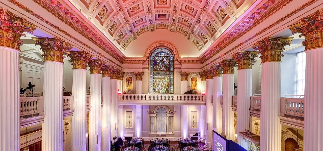 Neoclassical Palais ballroom with grand columns for upscale gala dinner and corporate event hosting.