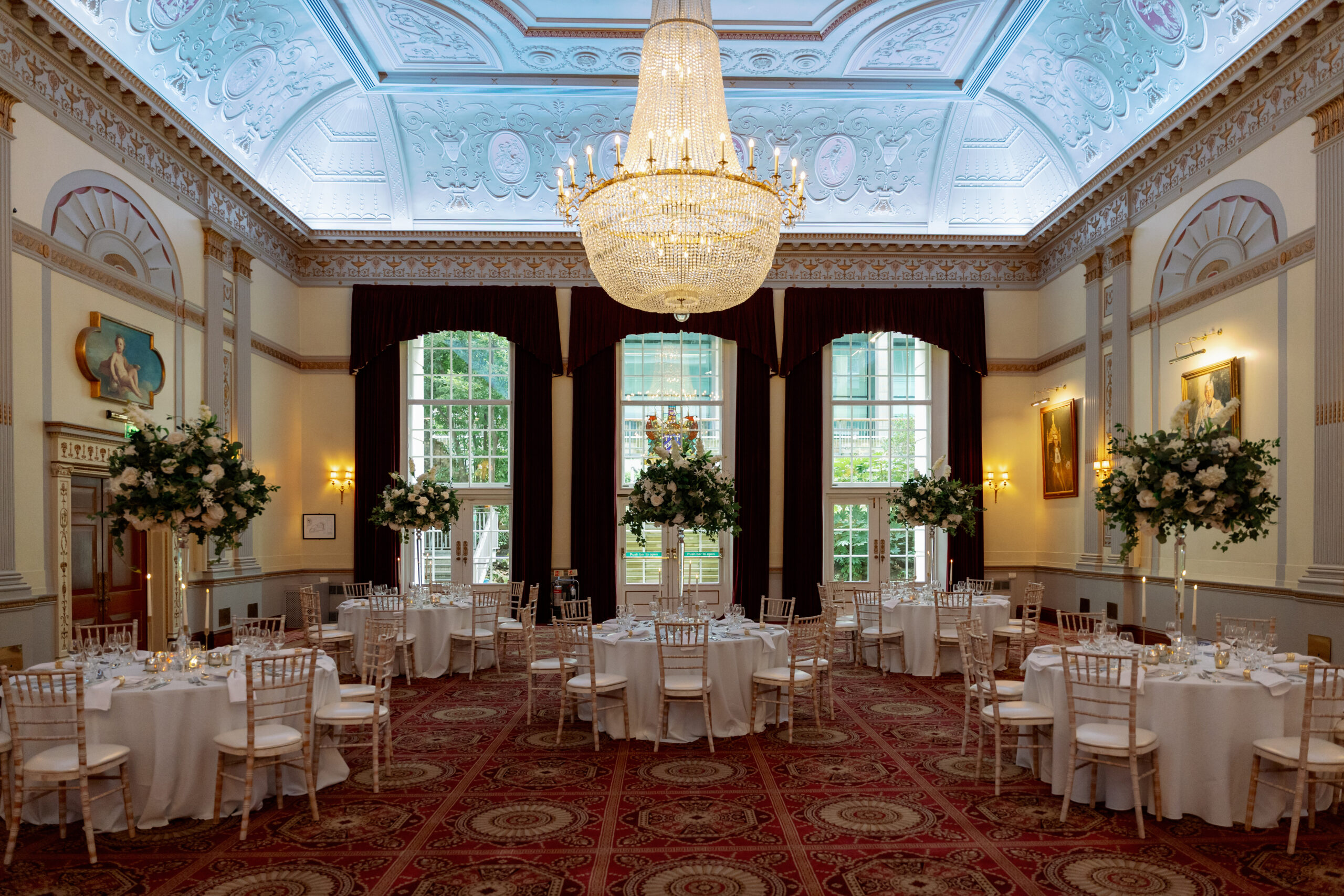 Ballroom in Palais with crystal chandelier, elegant banquet setup for gala dinner and weddings.