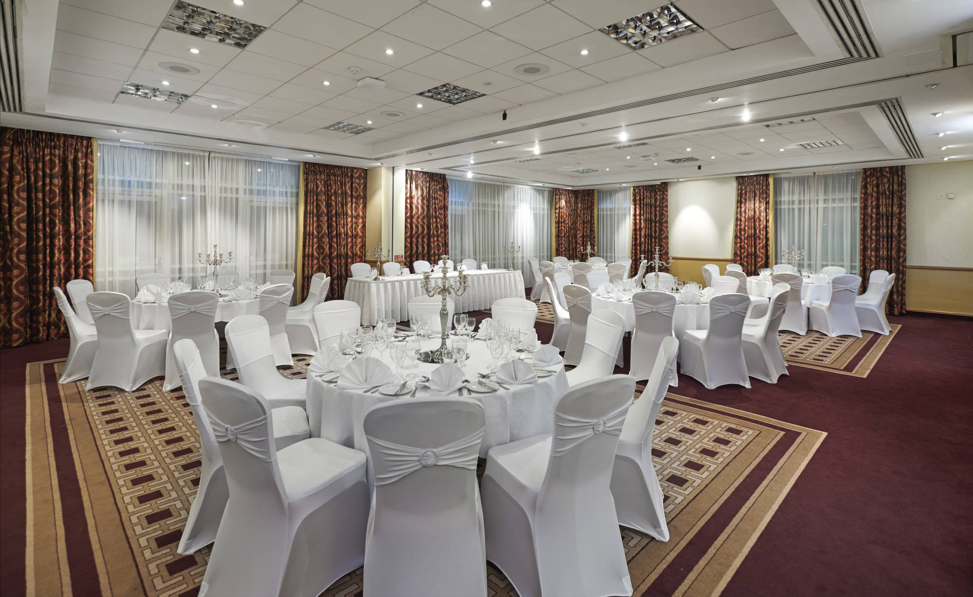 Main Hall banquet room with round tables, perfect for corporate dinner or wedding venue rental.