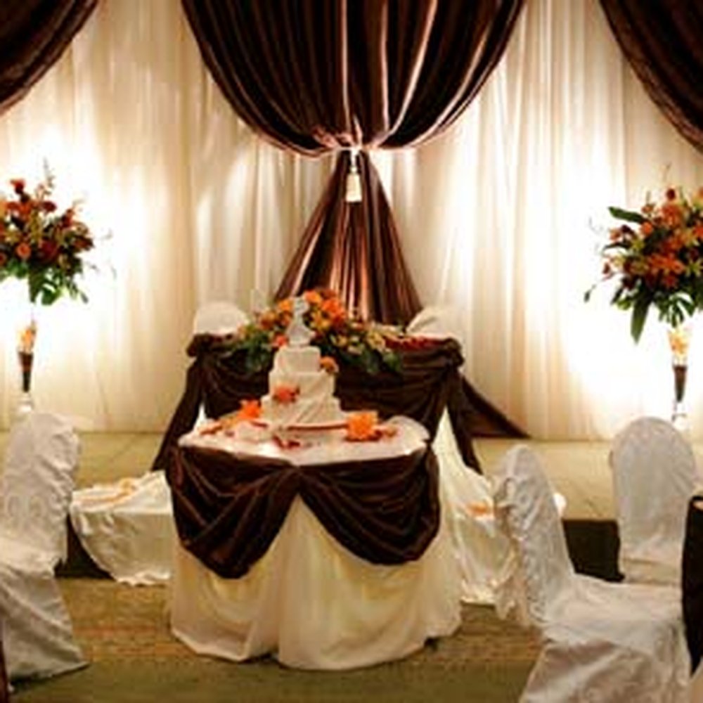 Main Hall at Crofton Halls wedding venue with elegant pipe-and-drape and floral pedestals.