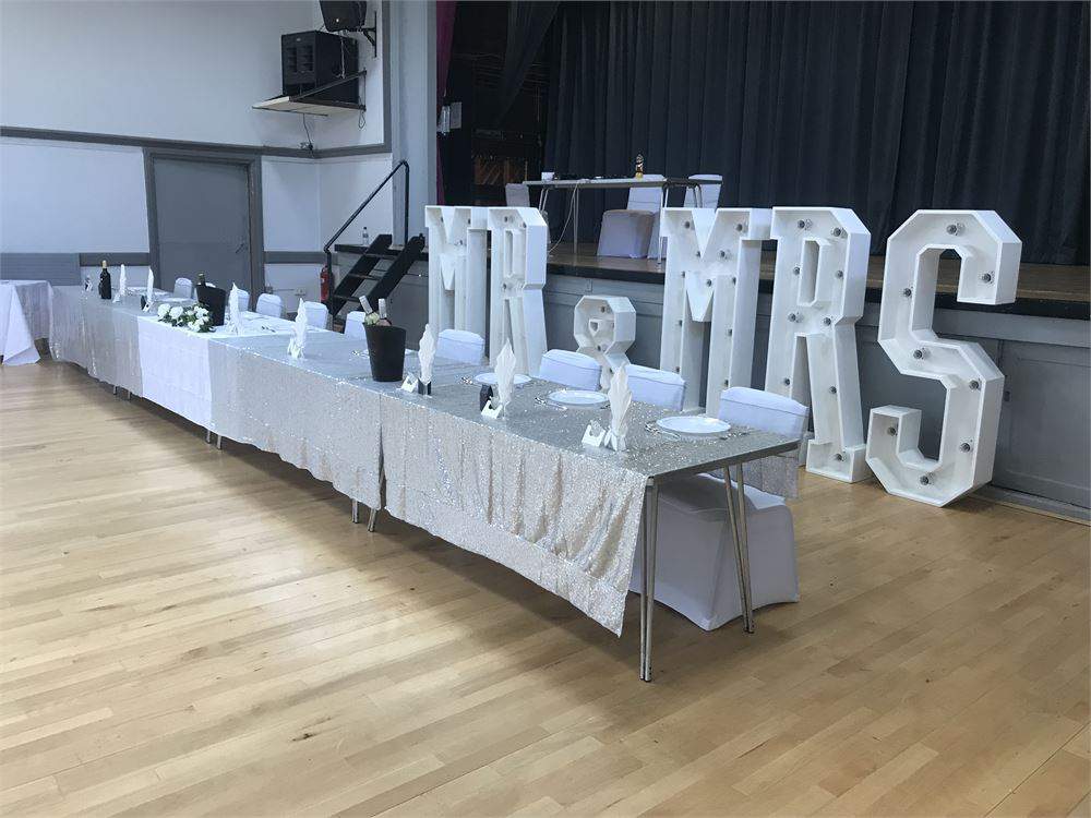 Main Hall wedding venue at Crofton Halls with marquee letters and banquet tables for event hire.
