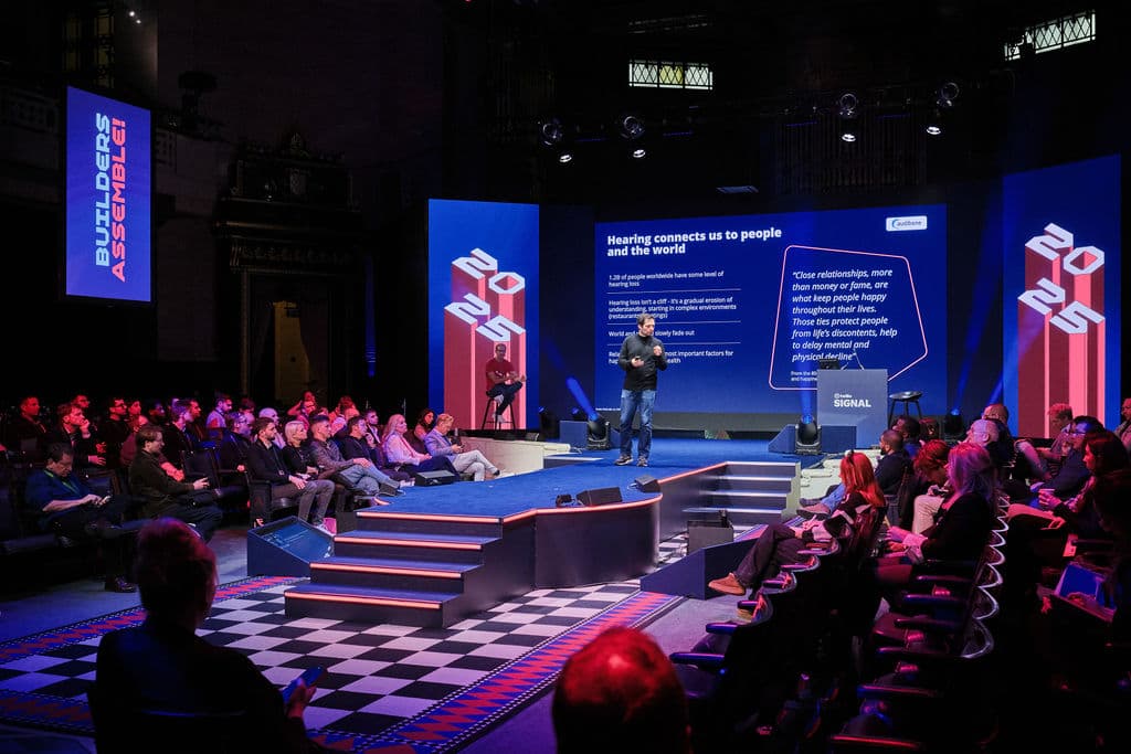 Corporate keynote stage with LED branding at The Grand Temple event venue.