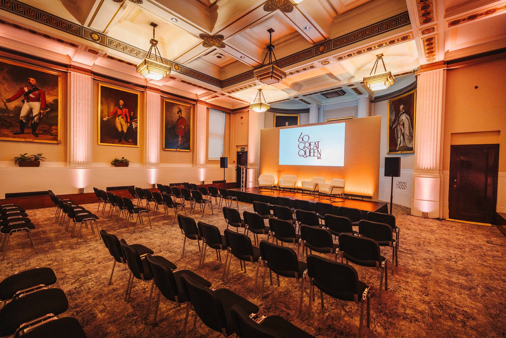 Historic theater venue at 60 Great Queen Street with stage lighting for keynote and panel events.