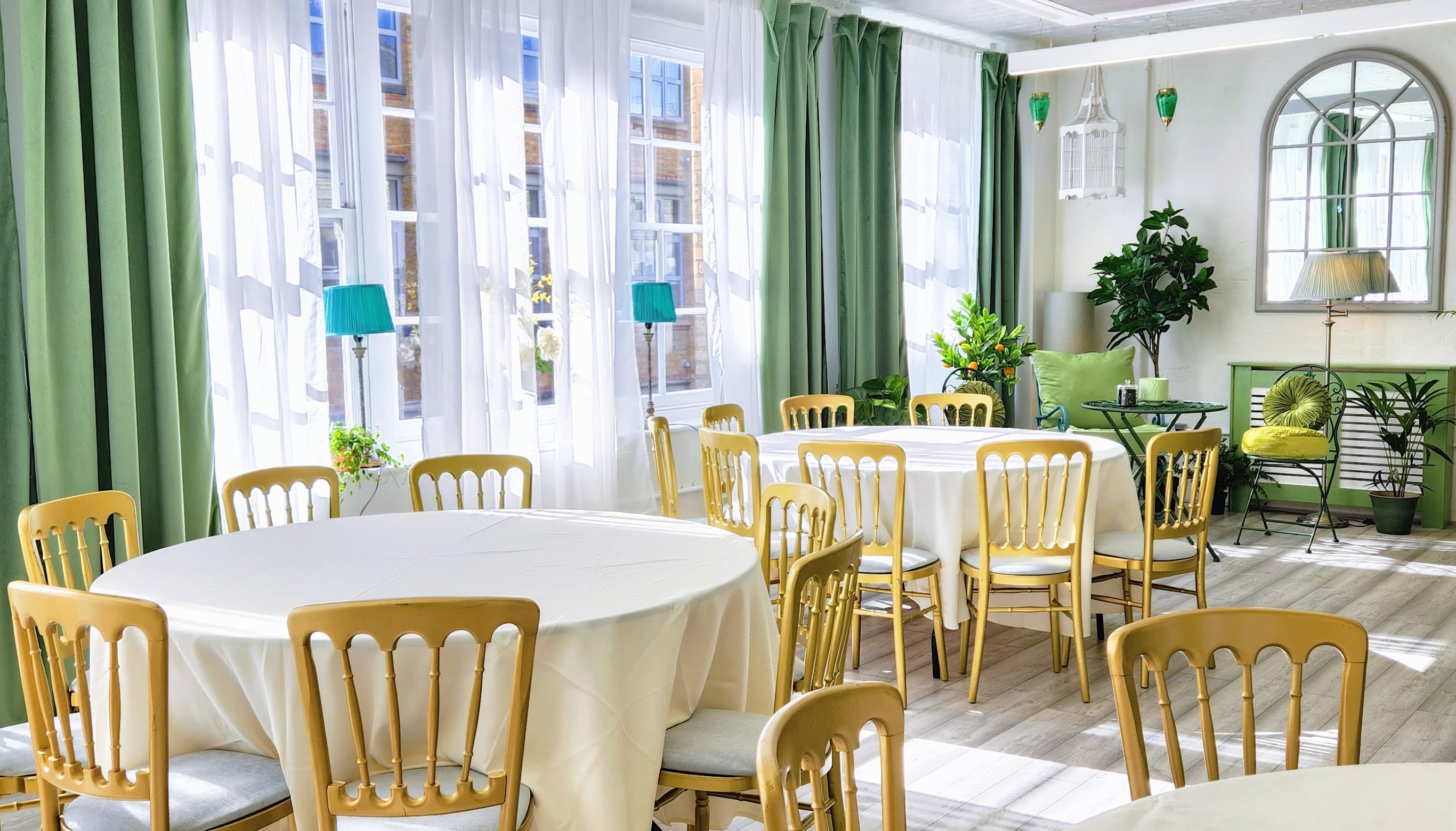 Underwood Lofts garden venue with gold Chiavari chairs for bridal showers and boutique luncheons.