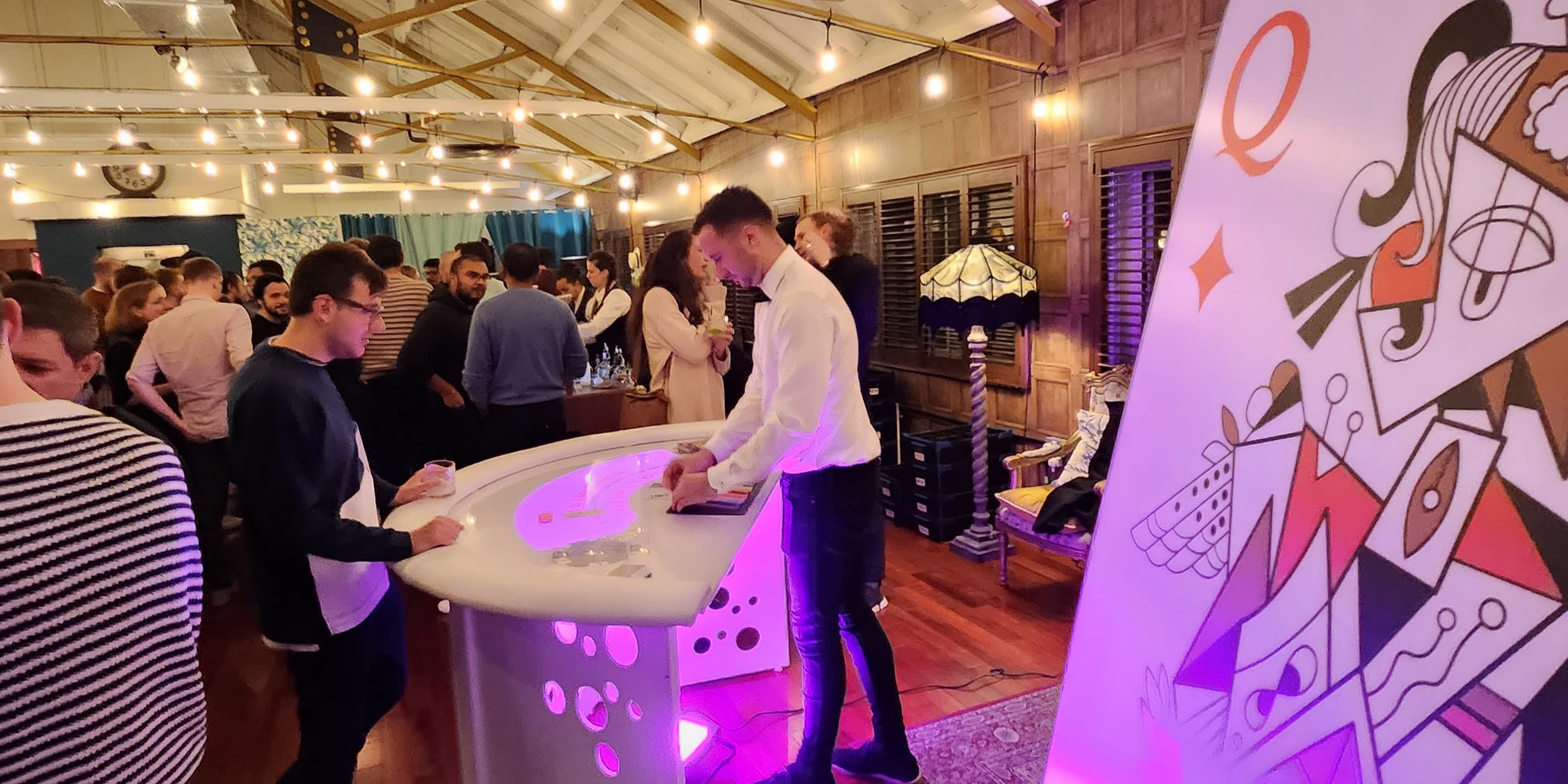 Corporate networking event at Lumiere Underwood featuring interactive LED tables and bistro lights.