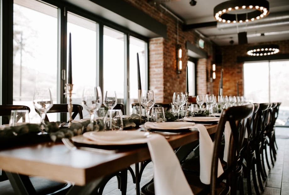 Tollgate Suite corporate dinner tablescape with rustic brick and greenery for boutique events.