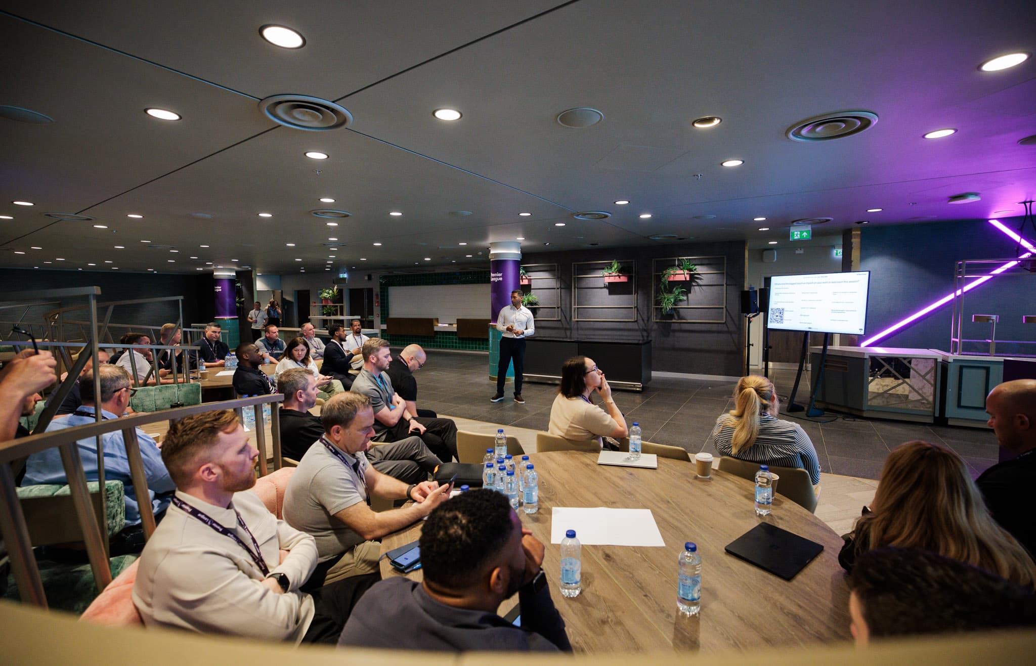 Number Nine Wembley: Corporate presentation space with round-table seating for hybrid events.