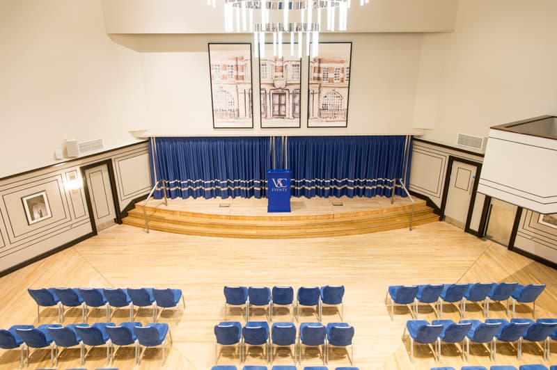Carisbrooke Hall theater setup with raised stage for corporate presentations and conferences.