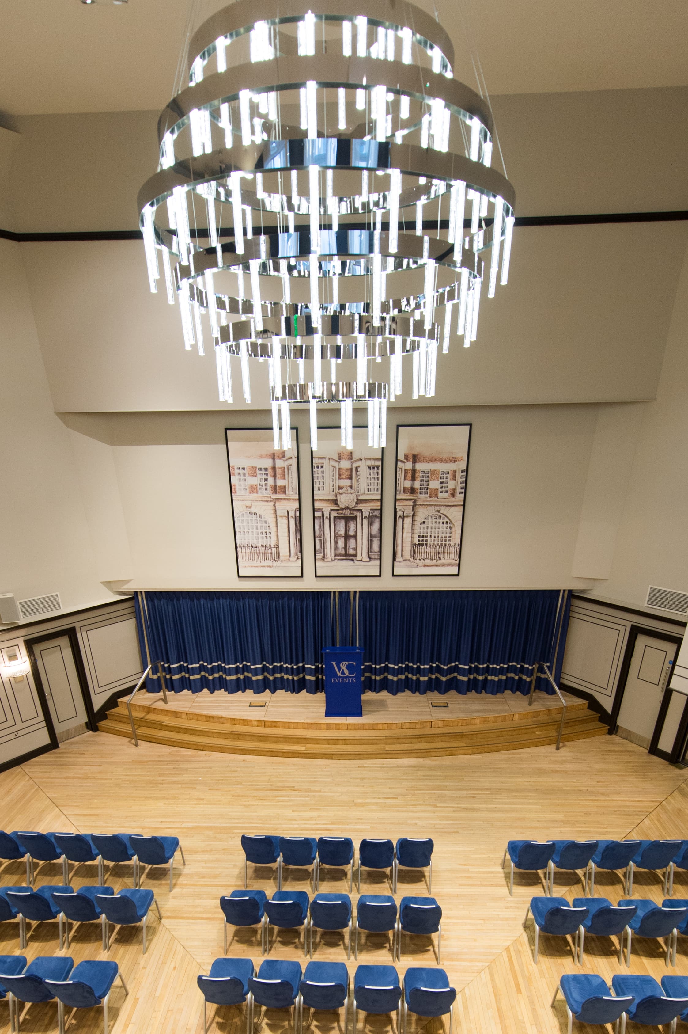 Carisbrooke Hall stage with branded lectern for corporate keynote presentations and events.