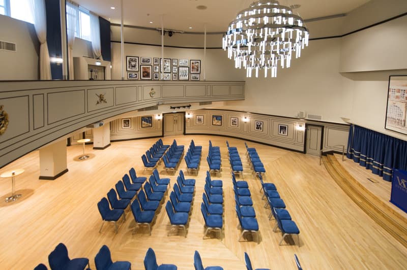 Carisbrooke Hall theater-style event venue with grand chandelier for conferences and seminars.