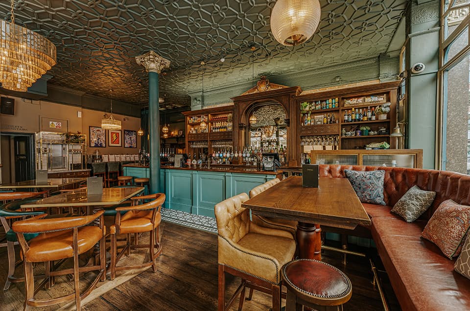 The Crown & Sceptre gastropub interior with plush banquettes for corporate mixers and events.