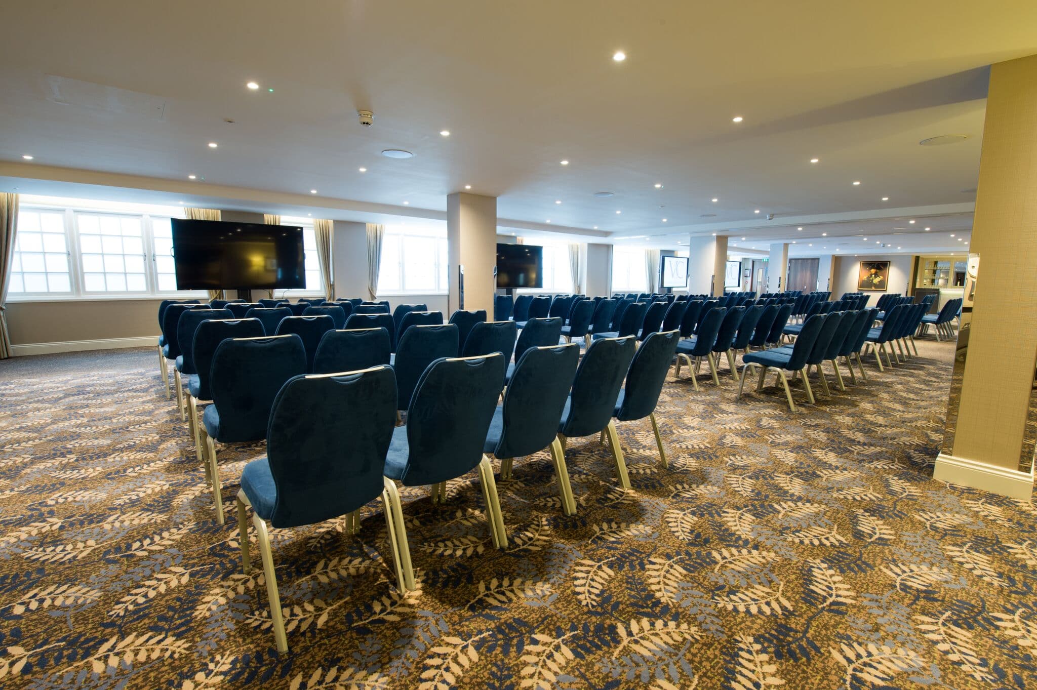 Theater-style conference room at Victory Services Club with structural pillars for event planning.