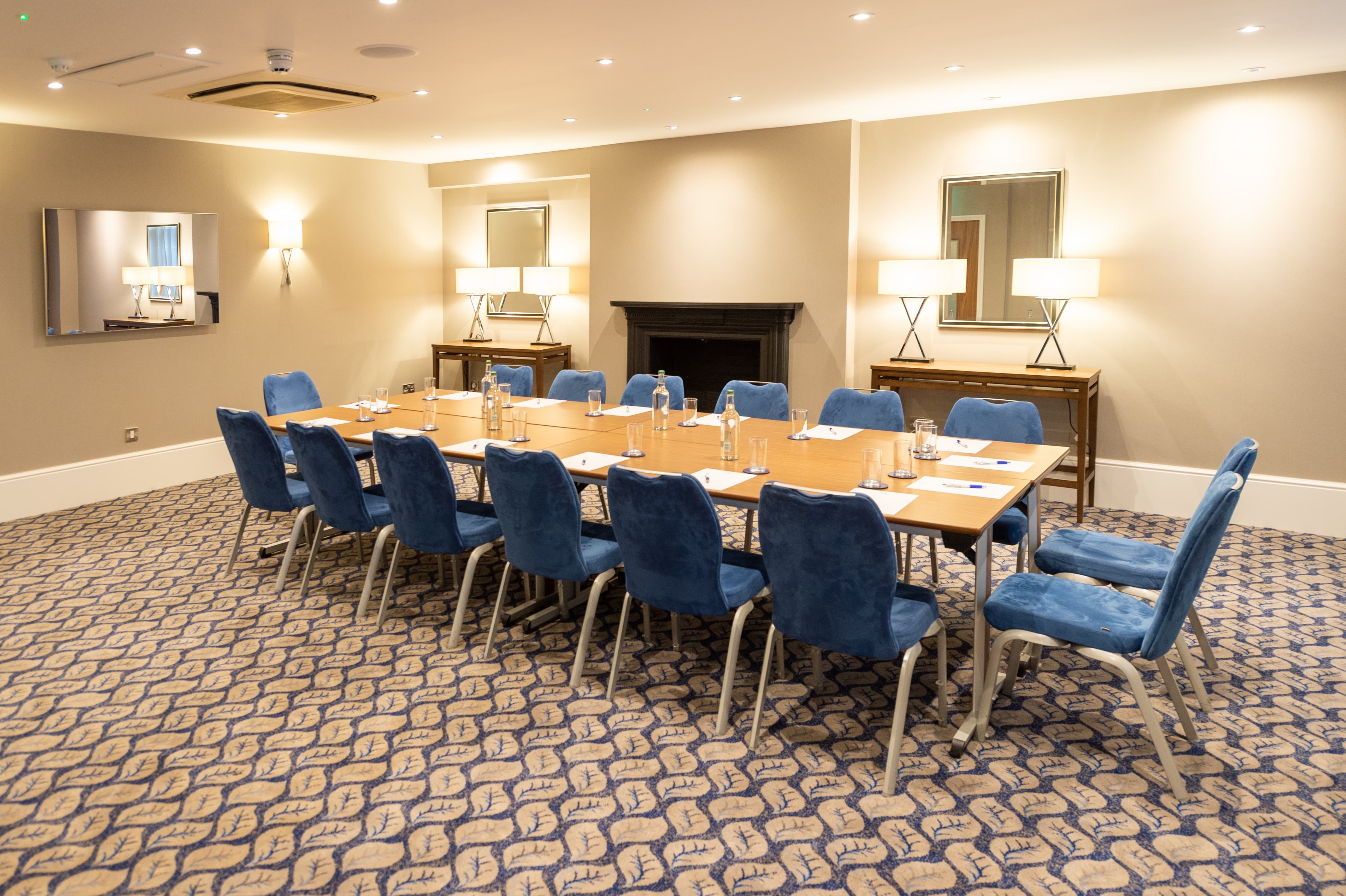 Boardroom at Victory Services Club with blue chairs for executive meetings and corporate events.
