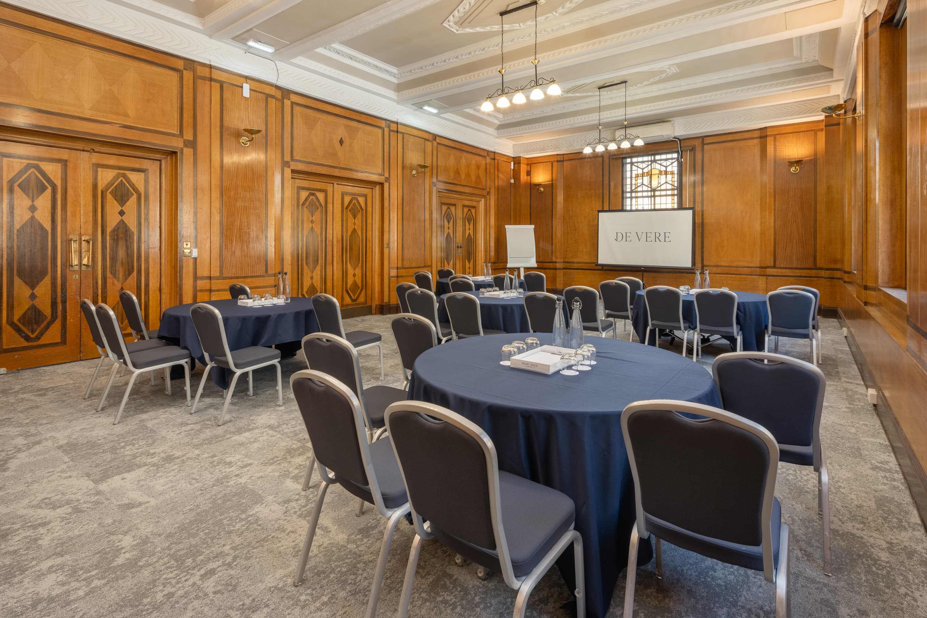 Essex Suite meeting room with wood paneling for corporate workshops and professional board sessions.