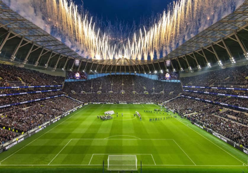 Tottenham Hotspur Stadium pitch with pyrotechnics for large-scale corporate event ceremonies.