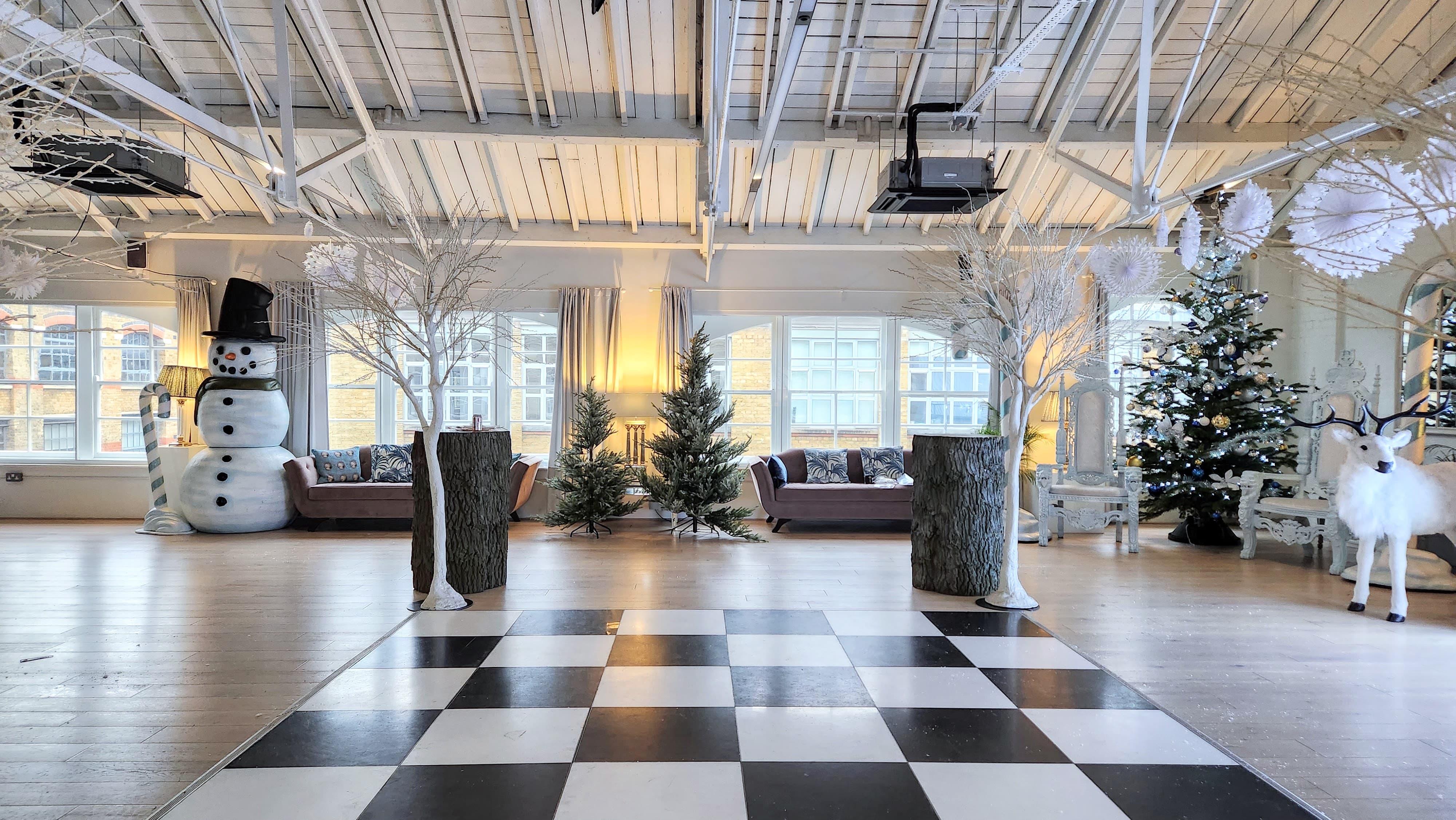 Industrial holiday party venue with dance floor for corporate Christmas events.