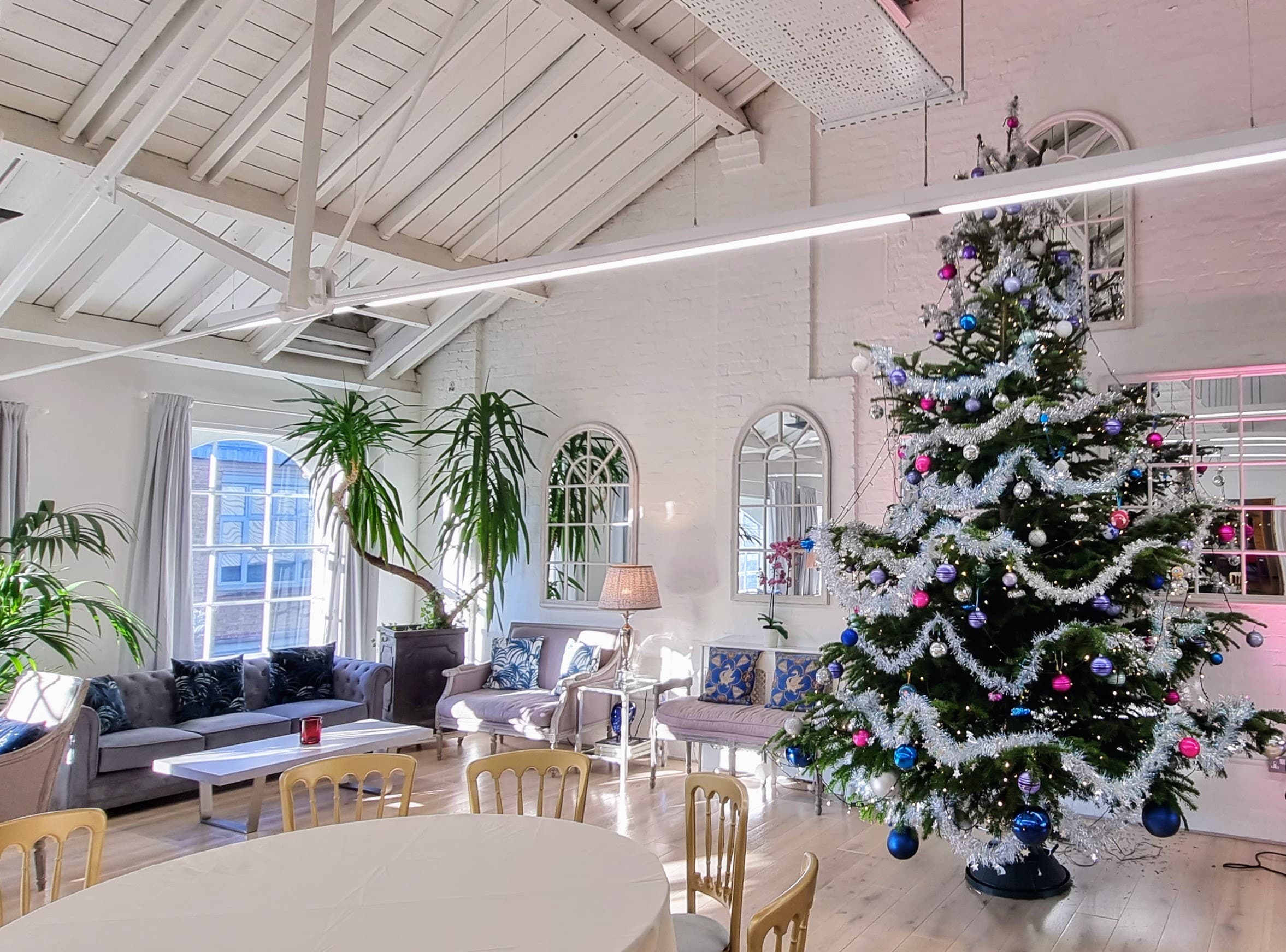 Upscale Christmas networking event space at Underwood with high ceilings.
