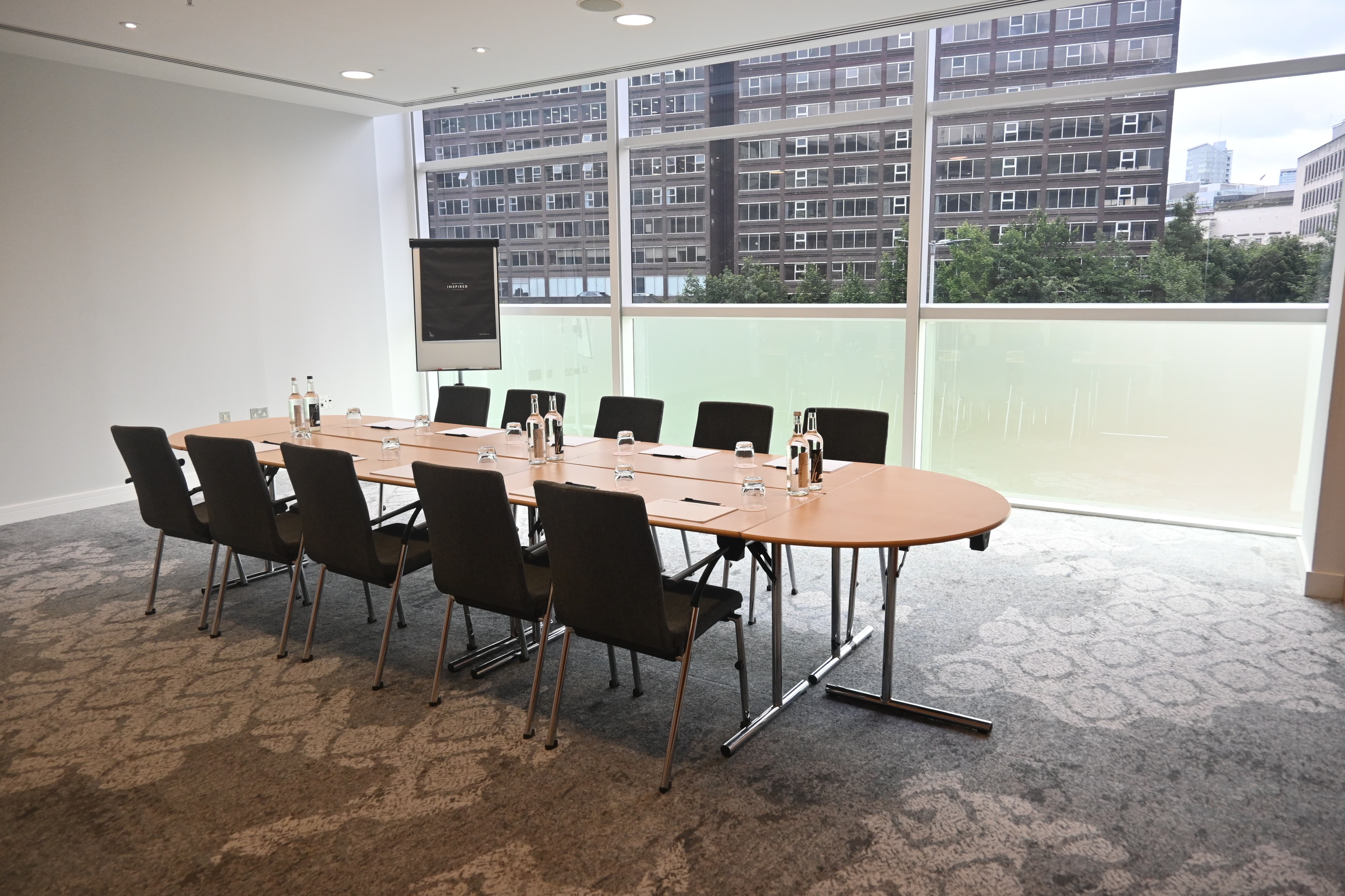Boardroom-style Meeting Room 7 at The Lowry Hotel, perfect for professional business conferences.