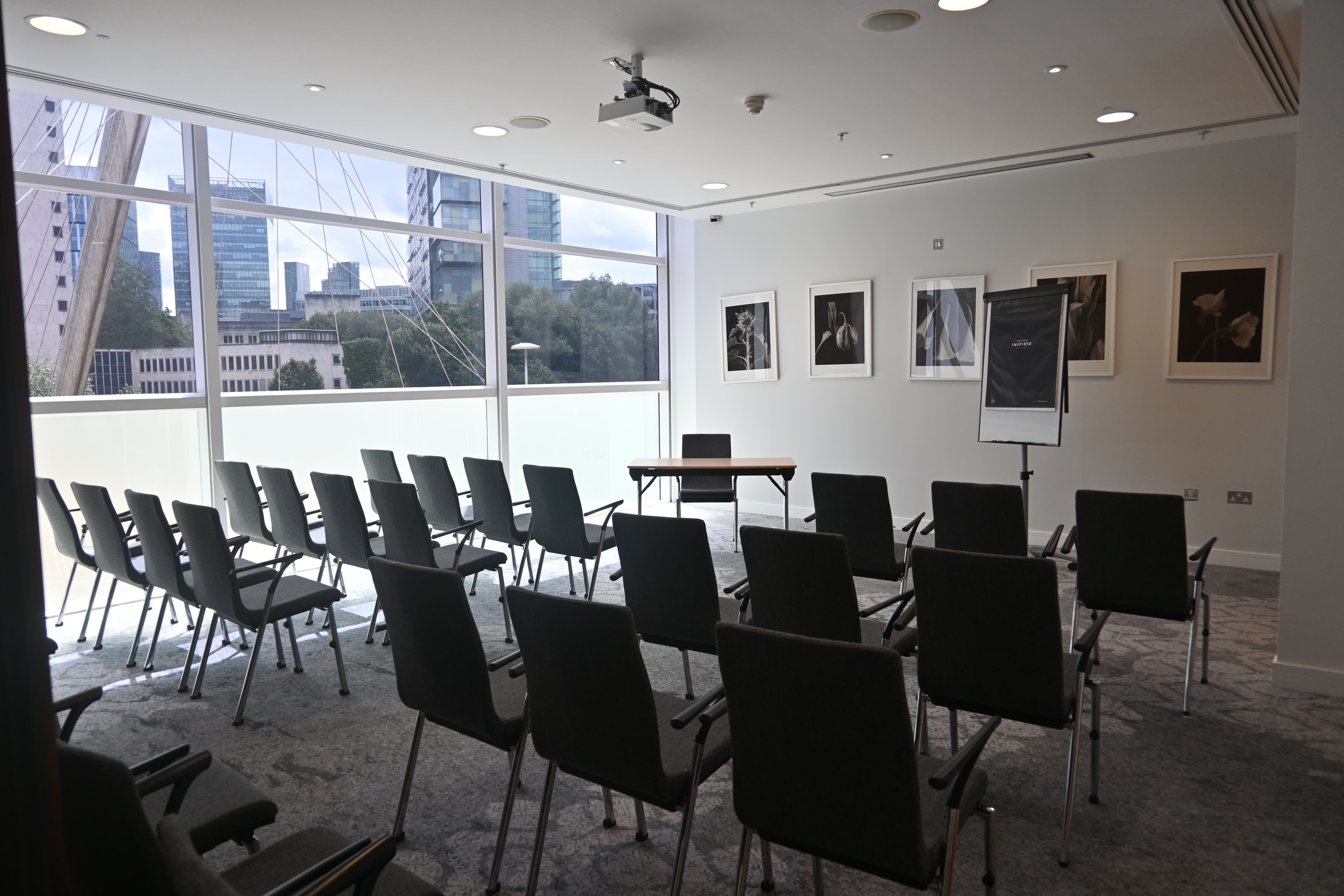Theater-style meeting room at The Lowry Hotel with floor-to-ceiling windows for seminars.