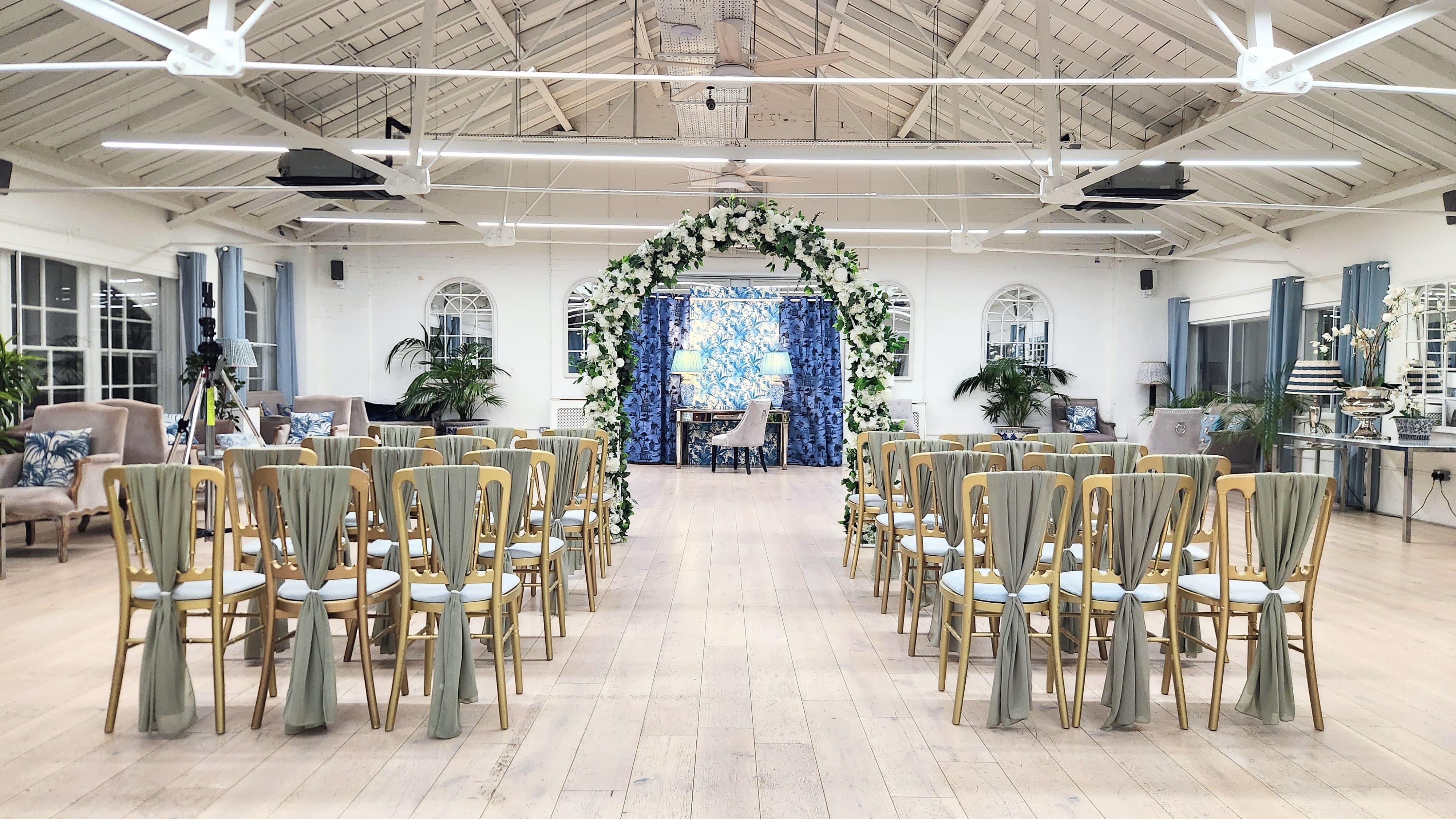 Light-filled wedding ceremony venue at Underwood with floral arch for elegant events.