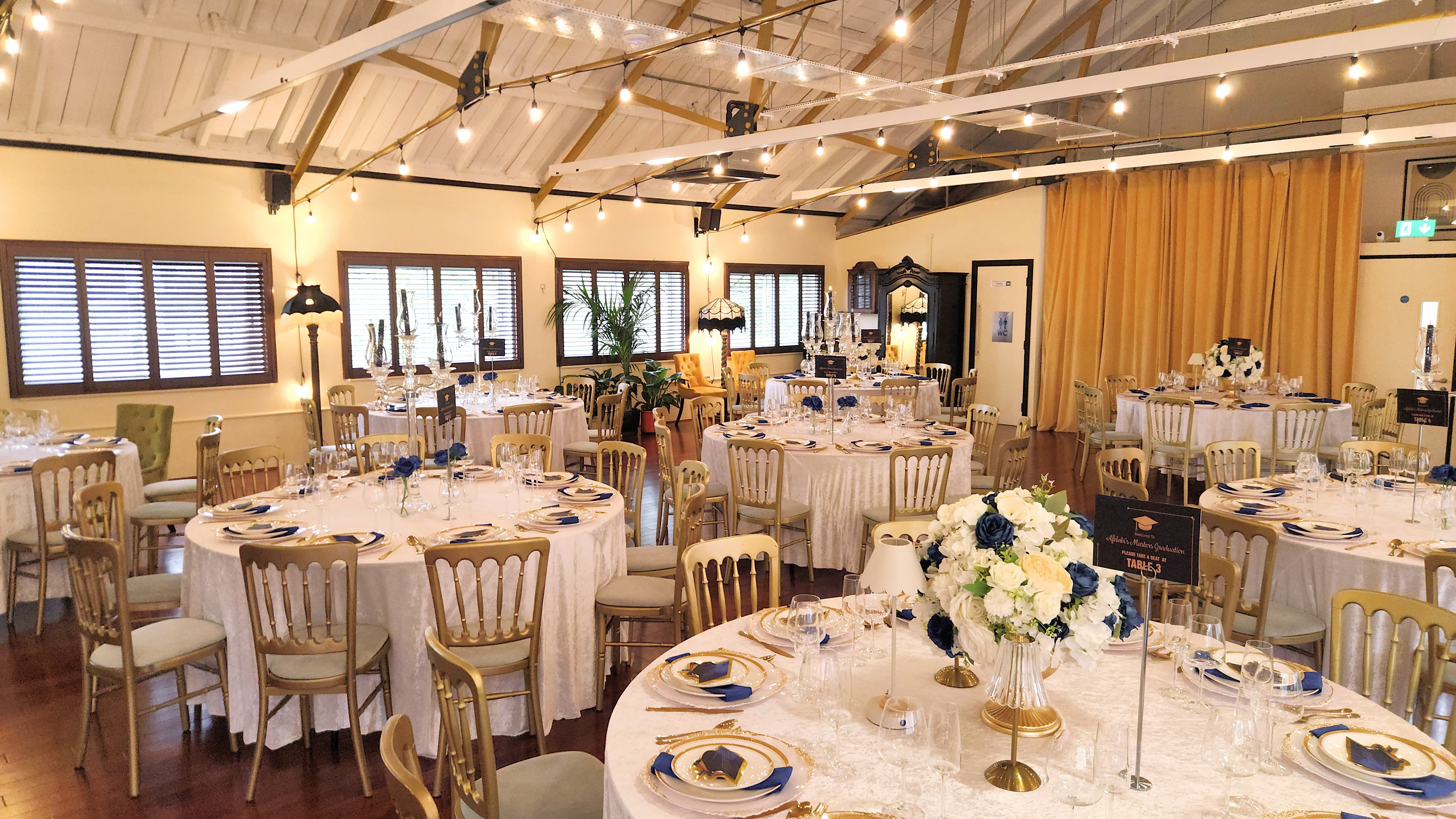Rustic-chic wedding reception at Lumiere Underwood with gold chairs and ambient string lighting.