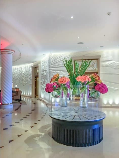 Luxury hotel lobby with floral centerpiece for VIP events and corporate registration.
