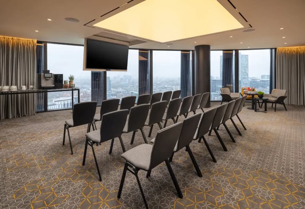 Theater-style breakout room with panoramic views for executive meetings and corporate workshops.