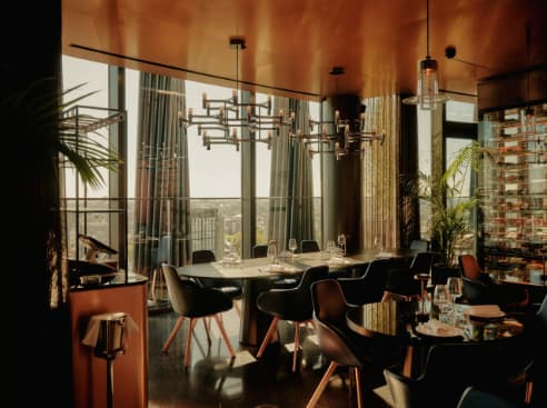 Private dining space at art'otel London Hoxton with floor-to-ceiling views for executive meetings.