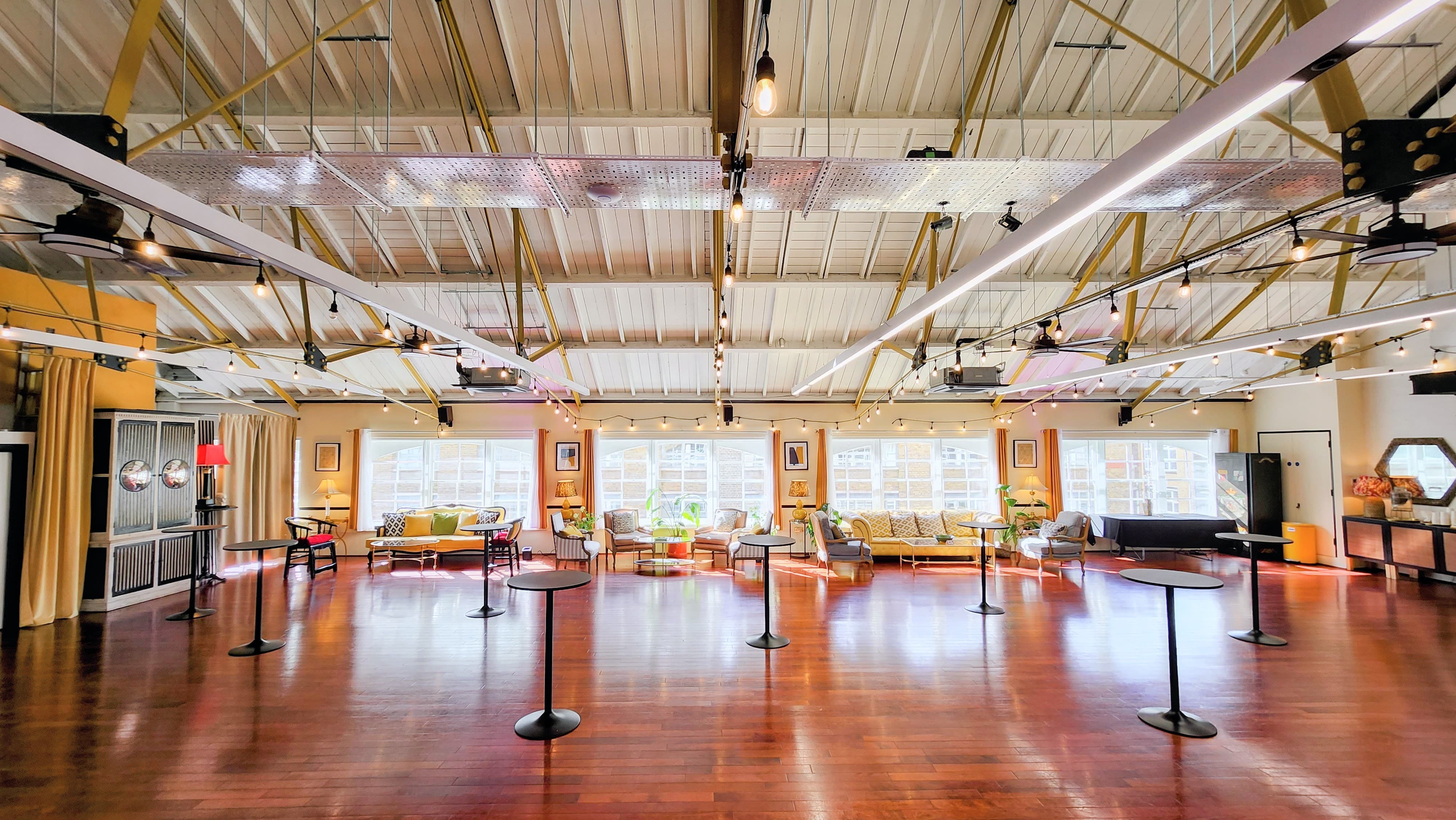 Industrial-chic event space with high-top furniture for cocktail receptions and networking mixers.
