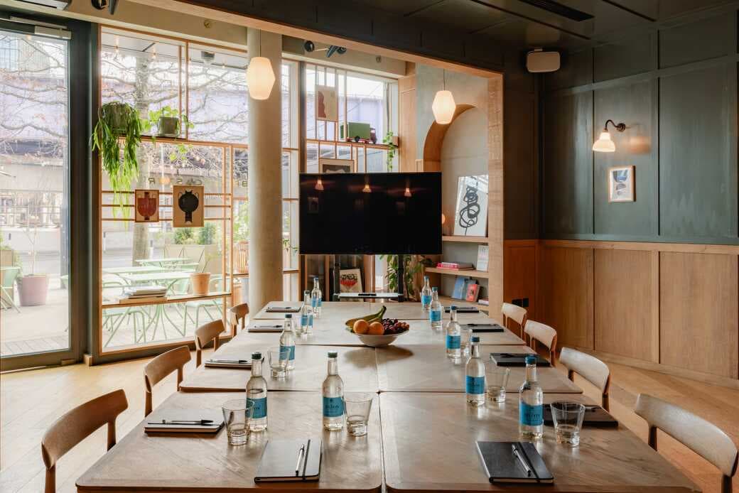 The Playroom boardroom with natural light for small-group strategy sessions and corporate meetings.