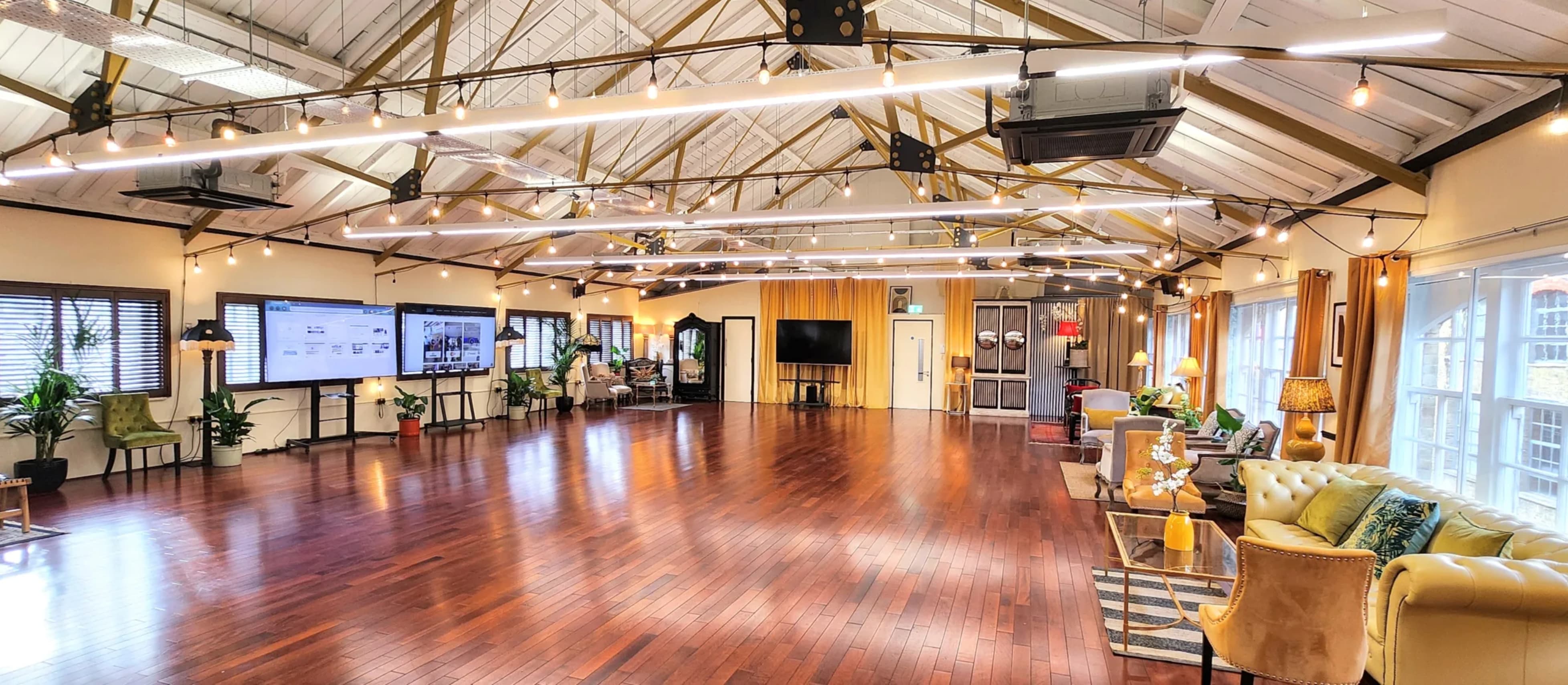 Industrial-chic event venue with hardwood floors for creative workshops and networking events.